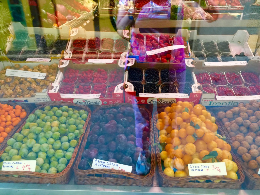 Through the window of a fruit and vegetable shop in Treviso, where produce is displayed as jewels.